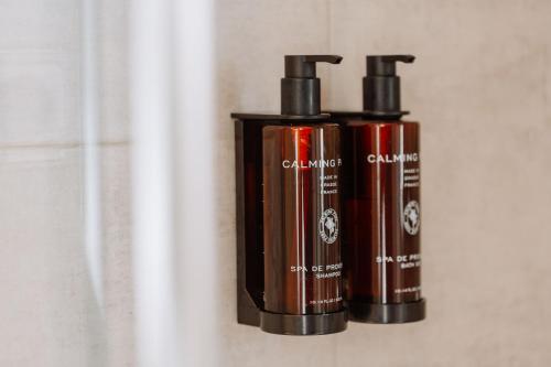 two brown bottles of soap on a wall at HolaCamp Sitges Garrofer in Sitges
