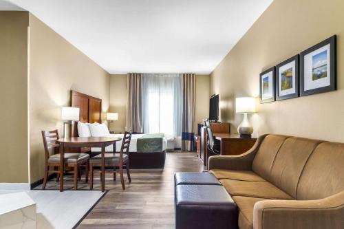 a hotel room with a couch and a table at Comfort Suites in Mount Vernon