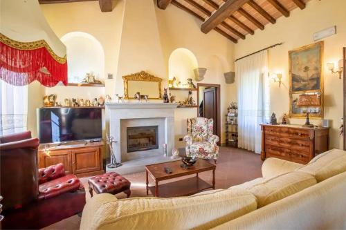 a living room with a couch and a fireplace at Villa San Vicenzo by Mmega in Calzolaro