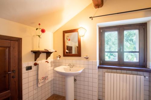 a bathroom with a sink and a window at Villa San Vicenzo by Mmega in Calzolaro