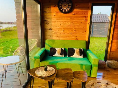a living room with a green couch and a table at Uroczy zakątek in Silice