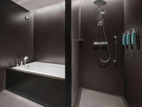 a bathroom with a tub and a sink and a shower at Hilton Garden Inn Xi'An Bell Tower in Xi'an