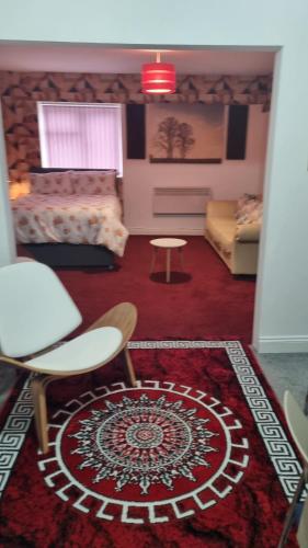 a living room with a bed and a rug at Apartment 3 in Leicester