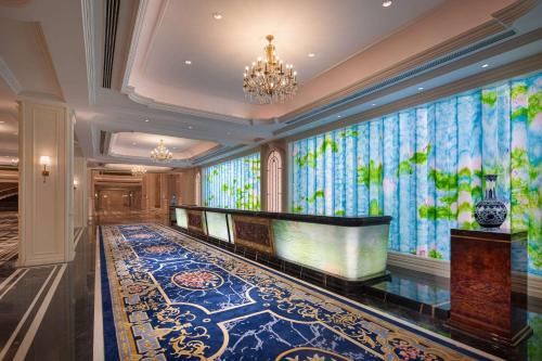 a lobby with a large wall of windows and a pool at Wyndham Taian West in Tai'an