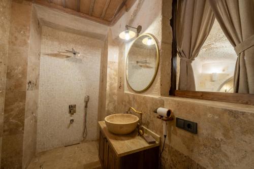 a bathroom with a sink and a mirror at Library Cave House in Urgup