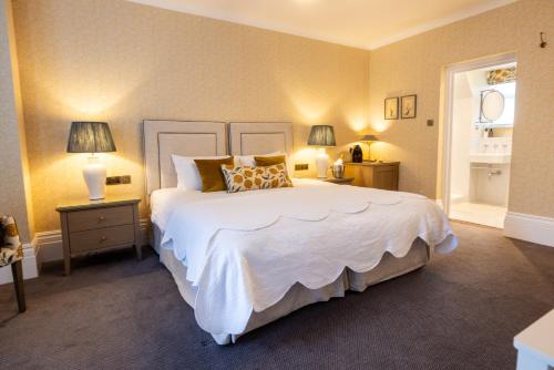 a bedroom with a large white bed and two lamps at Best Western Plus The Connaught Hotel and Spa in Bournemouth