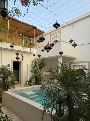 a house with a swimming pool in the yard at Riad Ait El Mouden in Agadir