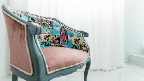 a chair sitting in a room next to a window at LianHome b&b "Terrazzino" in Lucera
