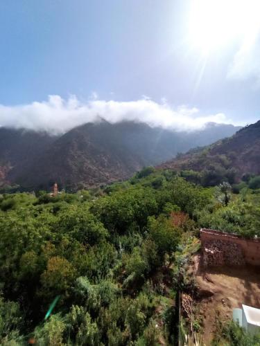 a view of a mountain with clouds in the sky at Gite Gougadir Imoughlad in Imlil