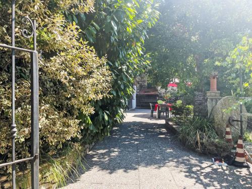 a garden with a pathway with trees and a fence at Holiday Home Casa Simona - DOL134 by Interhome in Costa Carnara