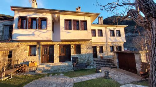 a large stone house with a yard at Αρχοντικό Βαρσάνη ! in Anilio Metsovo