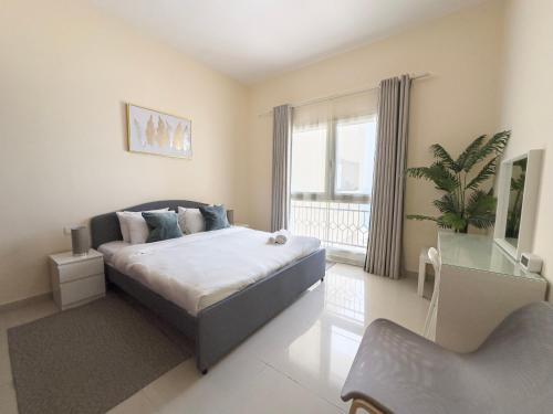 a bedroom with a bed and a large window at Royal Breeze Sea View One Bedroom Apartment in Ras al Khaimah