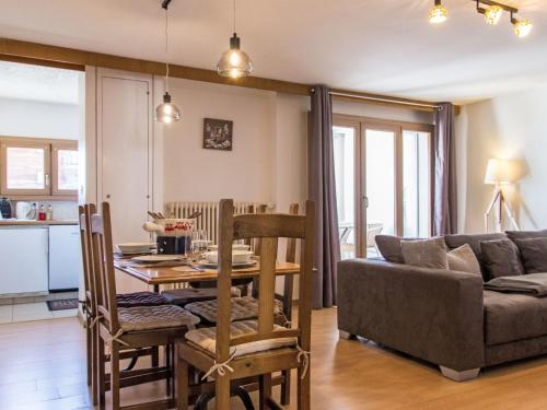 a living room with a table and a couch at Apartment Genets 150 D by Interhome in Nendaz