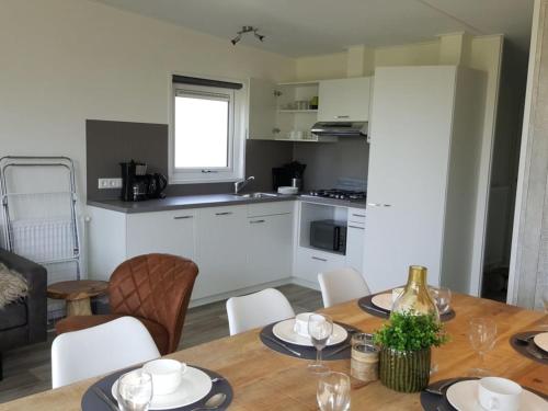 a kitchen and dining room with a table and chairs at Holiday Home Long Beach by Interhome in Retranchement