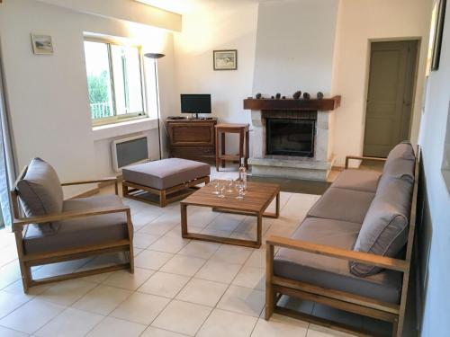 - un salon avec un canapé, des chaises et une cheminée dans l'établissement Holiday Home Le Bastidon by Interhome, à Besse-sur-Issole