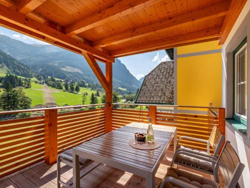 a wooden deck with a table and chairs on it at Apartment Grimming by Interhome in Kleinsölk