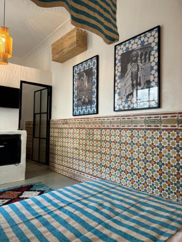 a bedroom with tiles on the wall and a bed at Riad Ait El Mouden in Agadir