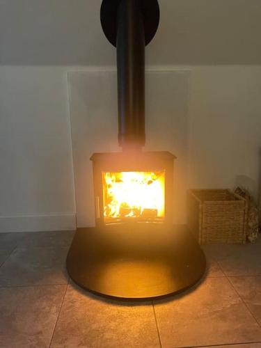 a fireplace in the corner of a room at The Orchard Apartment, Clyde Valley in Dalserf