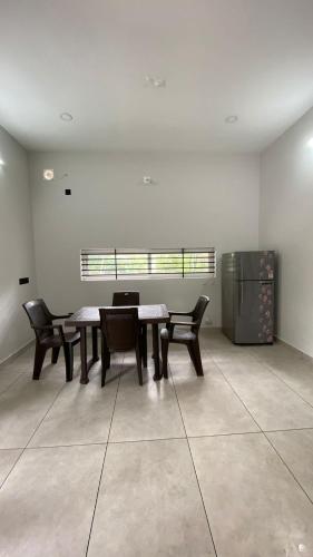 a room with a table and chairs and a window at Peaceful and Serene Space in Andūrkonam