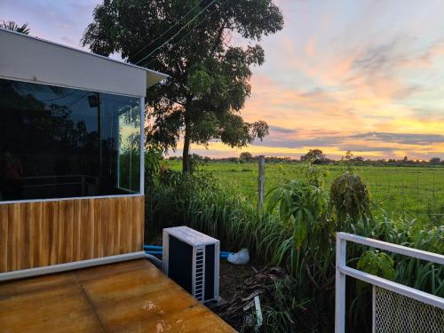 a house with a balcony with a view of a field at NATA Ville - นาตาวิลล์ สระบุรี in Ban Khok Klang