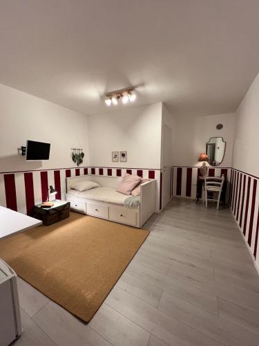 a bedroom with a bed and a desk and a television at La Cascina di Bea in Torre Boldone
