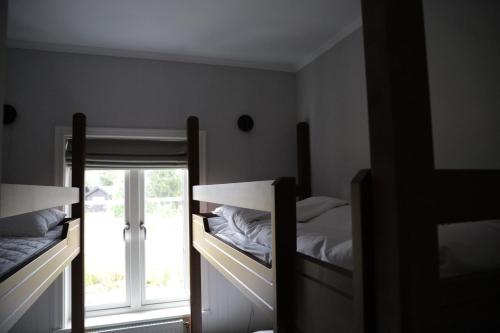 a bedroom with two bunk beds and a window at Gammelgården in  Högfjället