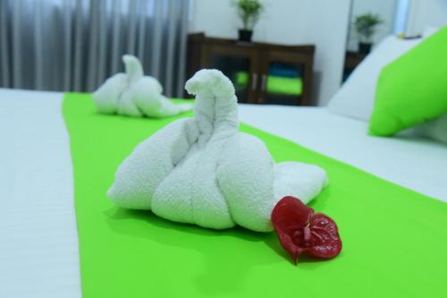 a bed with two white stuffed animals on it at Success Villa Hikkaduwa in Hikkaduwa