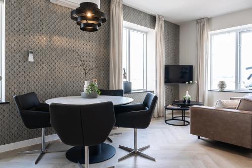 a living room with a table and chairs and a couch at Cozy 2-Bedroom Apartment in Central Nijmegen in Nijmegen