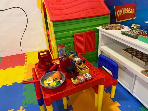 a lego house with a table with a bowl of food at Pousada Puerta Del Sol Rio das Ostras in Rio das Ostras