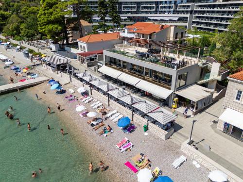 an overhead view of a beach with people in the water at Sun & Sea Residence in Mlini