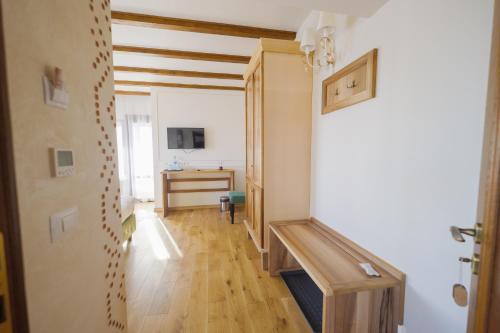 a hallway with a room with a sink and a desk at Crama de Piatra Winery Hotel & Conference Hall in Valea scheilor