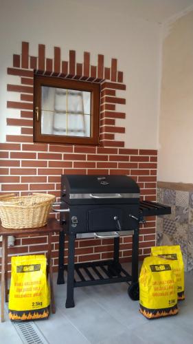 a grill sitting in front of a brick wall at Apartmány u jezera Fami*** in Doksy