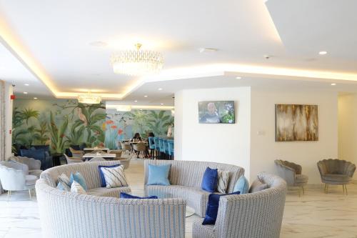 a lobby with couches and chairs and a table at Yaya Hotel & Apartments in Nairobi