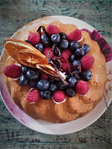 a cake with berries on top of it on a plate at Casa Taos in Marrakech