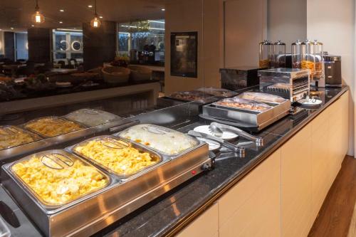 a buffet line with many different types of food at Hotel Gaivota Azores in Ponta Delgada