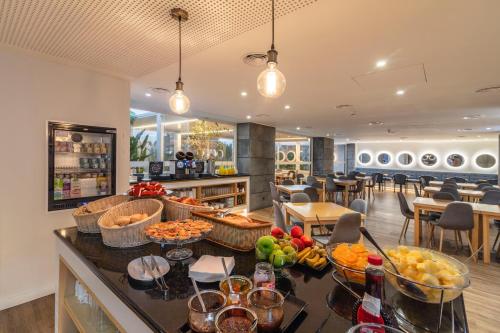 a lobby with a counter with fruits on it at Hotel Gaivota Azores in Ponta Delgada