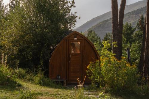 a person is standing inside of a small wooden house at Minds & Mountains Eco Lodge in La Molina
