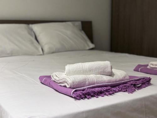 two towels sitting on top of a bed at Fort Chambray Holiday Villas & Apartments in Mġarr
