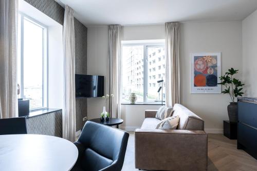 a living room with a couch and a table at Cozy 2-Bedroom Apartment in Central Nijmegen in Nijmegen