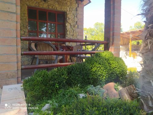 a patio with a table and chairs and a window at Forest Home in Golubovci
