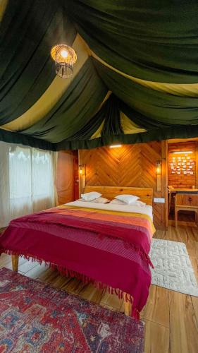 a bedroom with a bed in a tent at Jaadooghar x Dug Dug Camps, Bhimtal in Bhīm Tāl