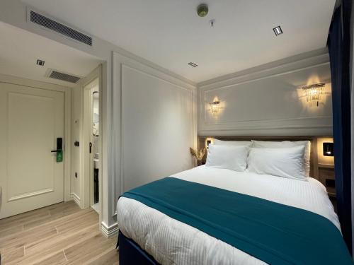 a bedroom with a large bed with a blue and white at Mona Bosphorus in Istanbul