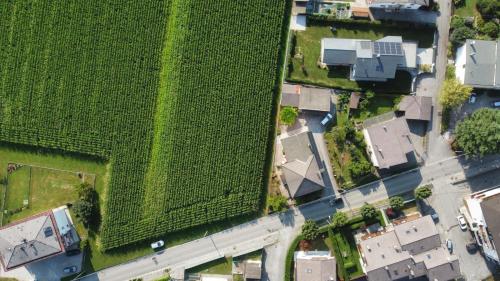 an overhead view of houses and a green field at B&B Colli's Dolomites in Belluno