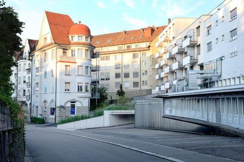 an empty street in front of a building at VISIONAPARTMENTS St Gallen - contactless check-in in St. Gallen