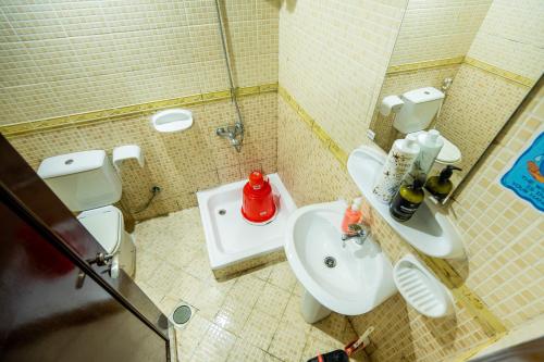 a small bathroom with a toilet and a sink at tourist Peaceful Family Rooms Abu Dhabi ME11APT baith al jannah LLC in Abu Dhabi