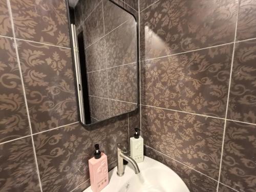 a bathroom with a sink and a mirror at Langkawi Simfoni Cassia Suite 04 9pax in Kuah