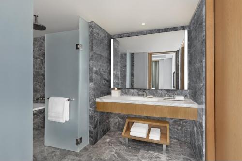 a bathroom with a sink and a mirror at The Westin Manila in Manila