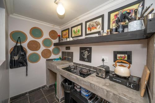 a kitchen with a stove and a counter top at Foxy Crocodile Bush Lodge & Kruger Safari's - No Loadshedding in Marloth Park