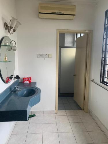 a bathroom with a blue sink and a mirror at Cityscape KL in Kuala Lumpur