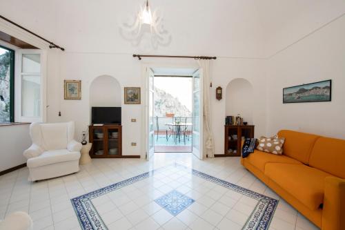 a living room with a couch and a chair at blue terrace Amalfi in Atrani